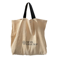 A beige, stylish and sustainable jute beach bag with The Spa Collection logo in black. Stylish and functional, eco-friendly bag.